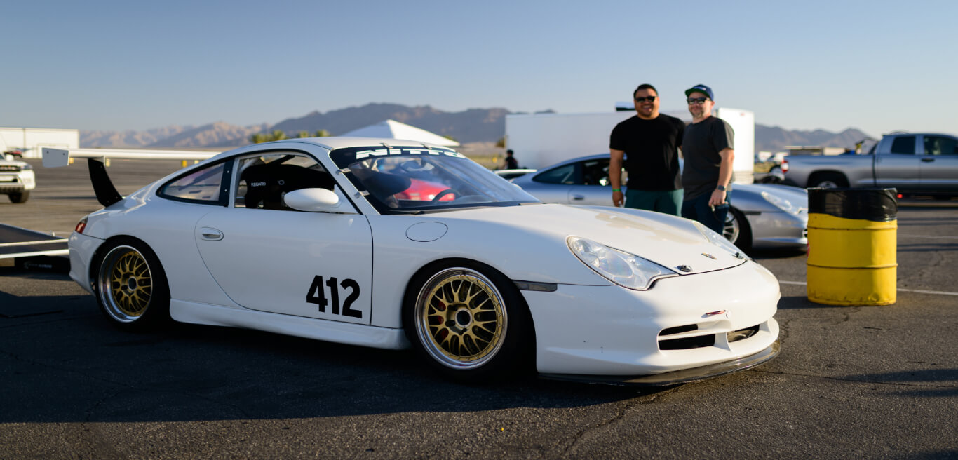 Third slide, People posed behind a car