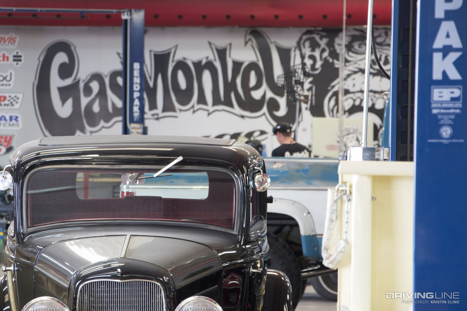 Hot Rod with Gas Monkey logo on a wall in the background