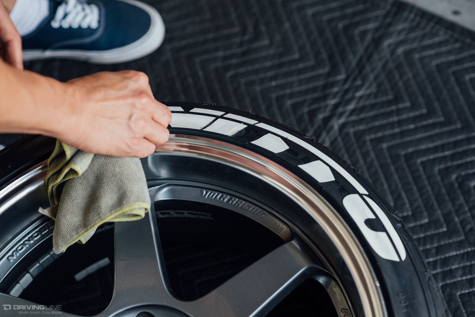 Finishing touches on Nitto tire decal with cloth