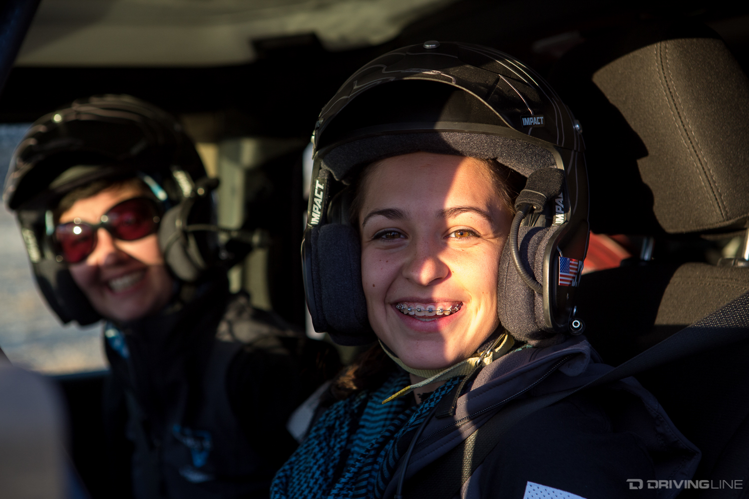 Bailey and Kendra belted in with helmets on, ready to go