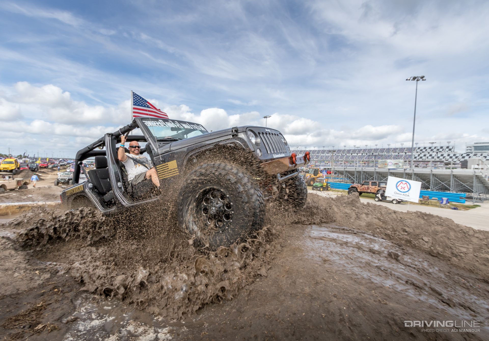 Jeep driving through the mud in the Daytona Speedway infield at Jeep Beach