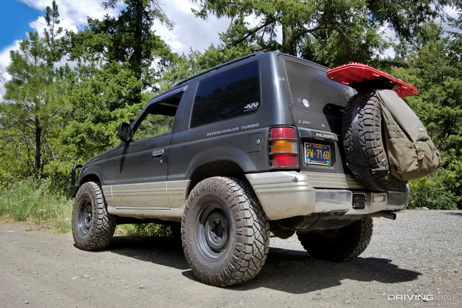 Mitsubishi Pajero with Nitto Ridge Grapplers and fifteen52 Analog HD wheels, complete with Maxtrax and a Trasharoo container