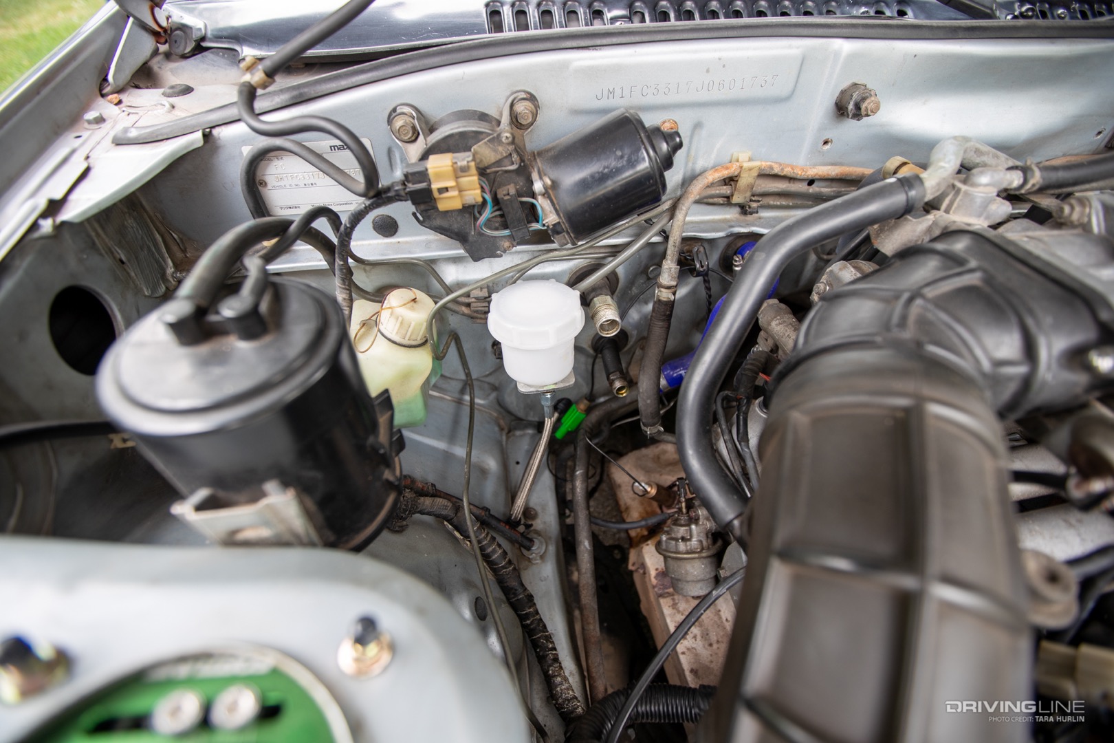 Brake fluid reservoir for hydraulic hand brake placed on firewall