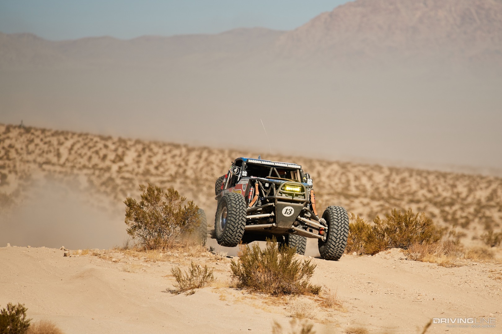 Bailey Cole driving his rig up over a berm