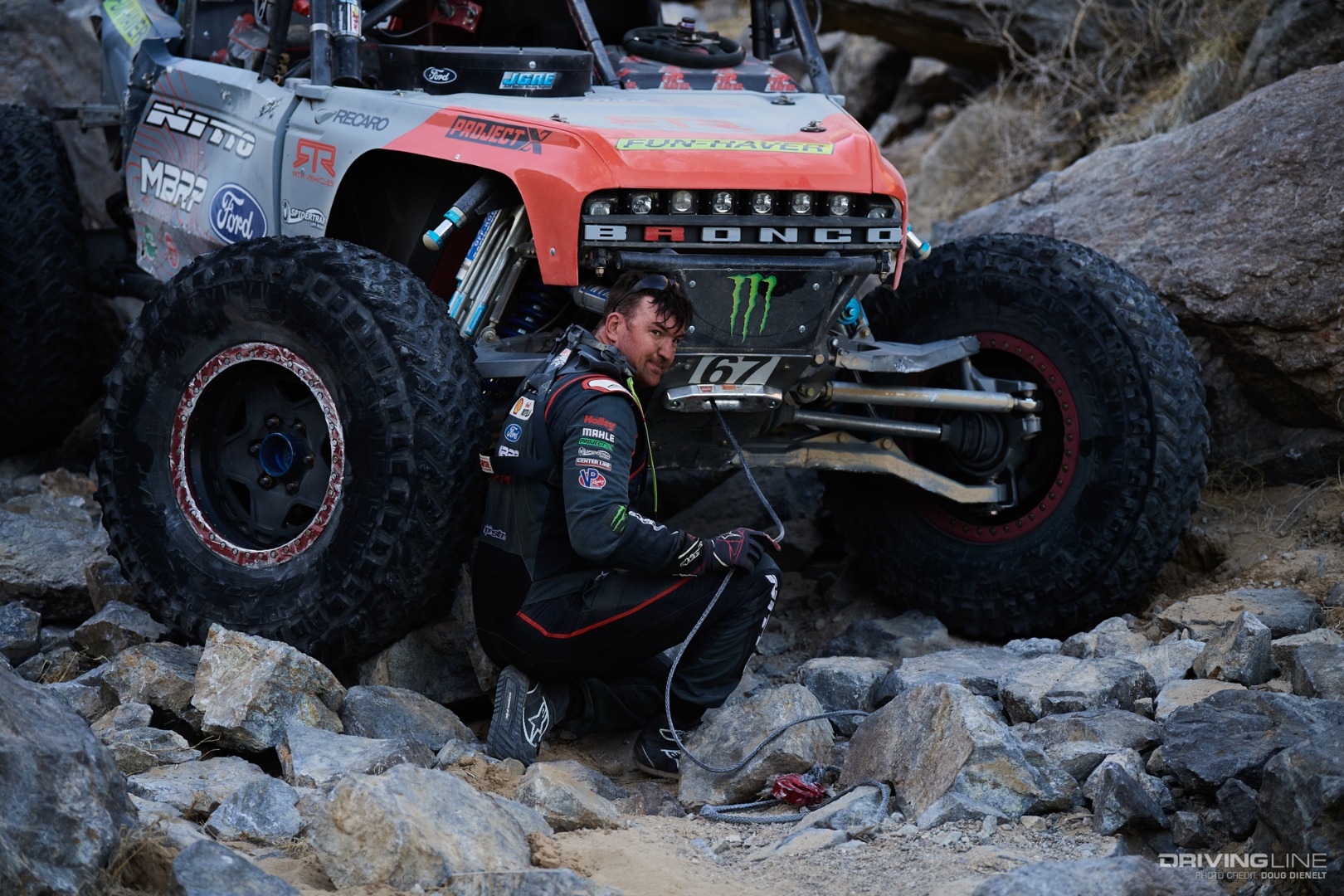 Loren Healy sitting outside of his rig in the rocks