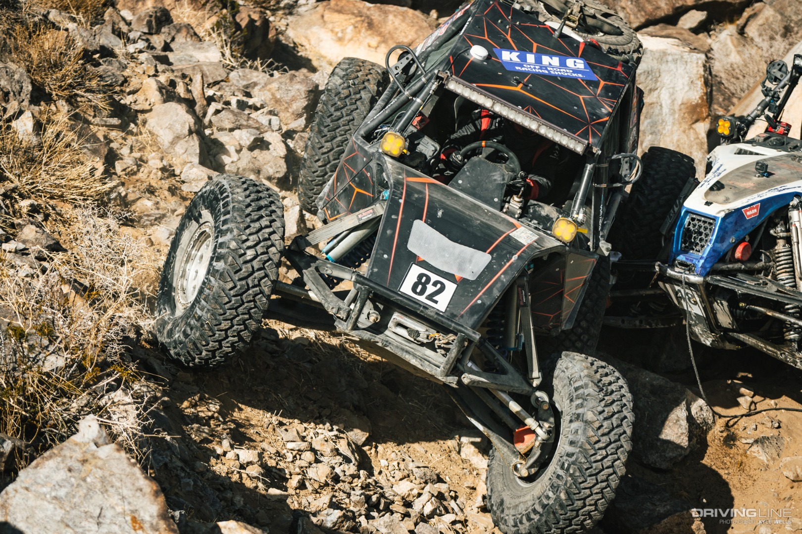 JP Gomez driving over Cameron Steele's wheel in the rocks