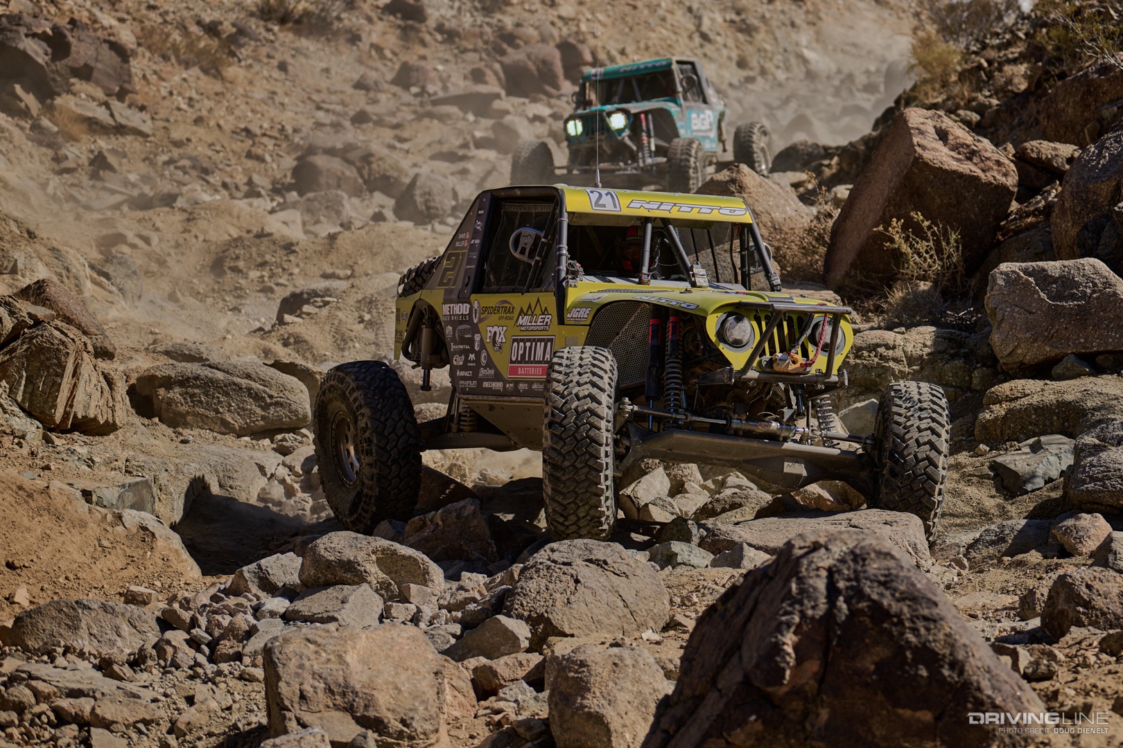 Erik Miller drives through a rocky canyon ahead of Josh Blyler
