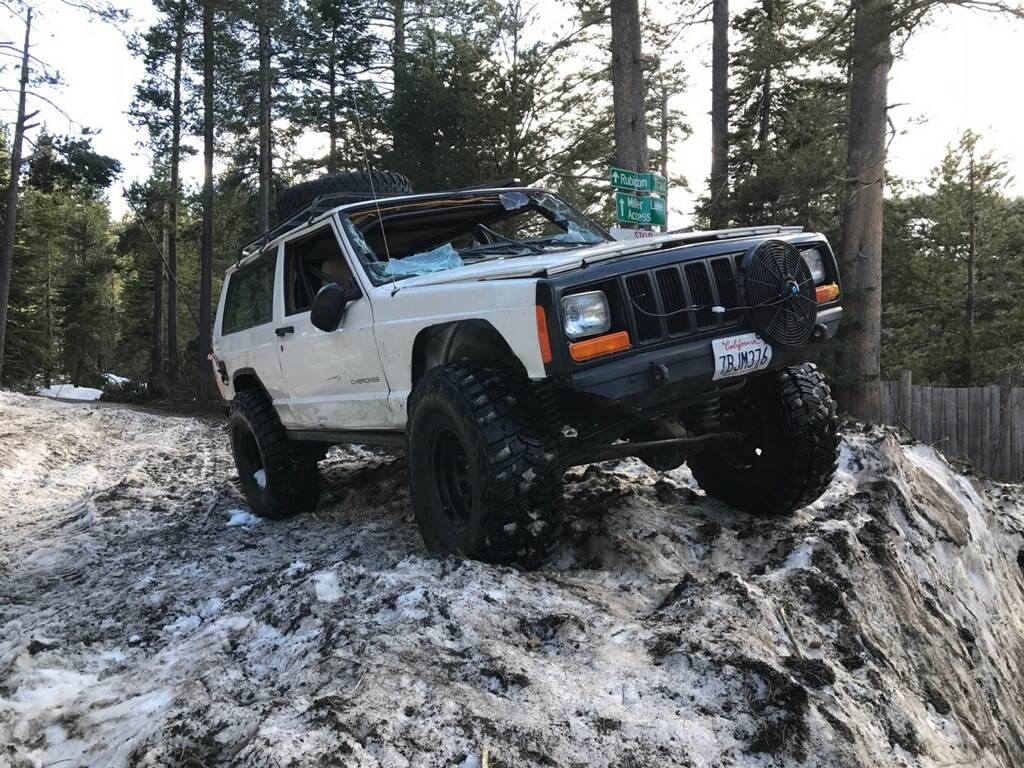 White Jeep Cherokee on a snow berm