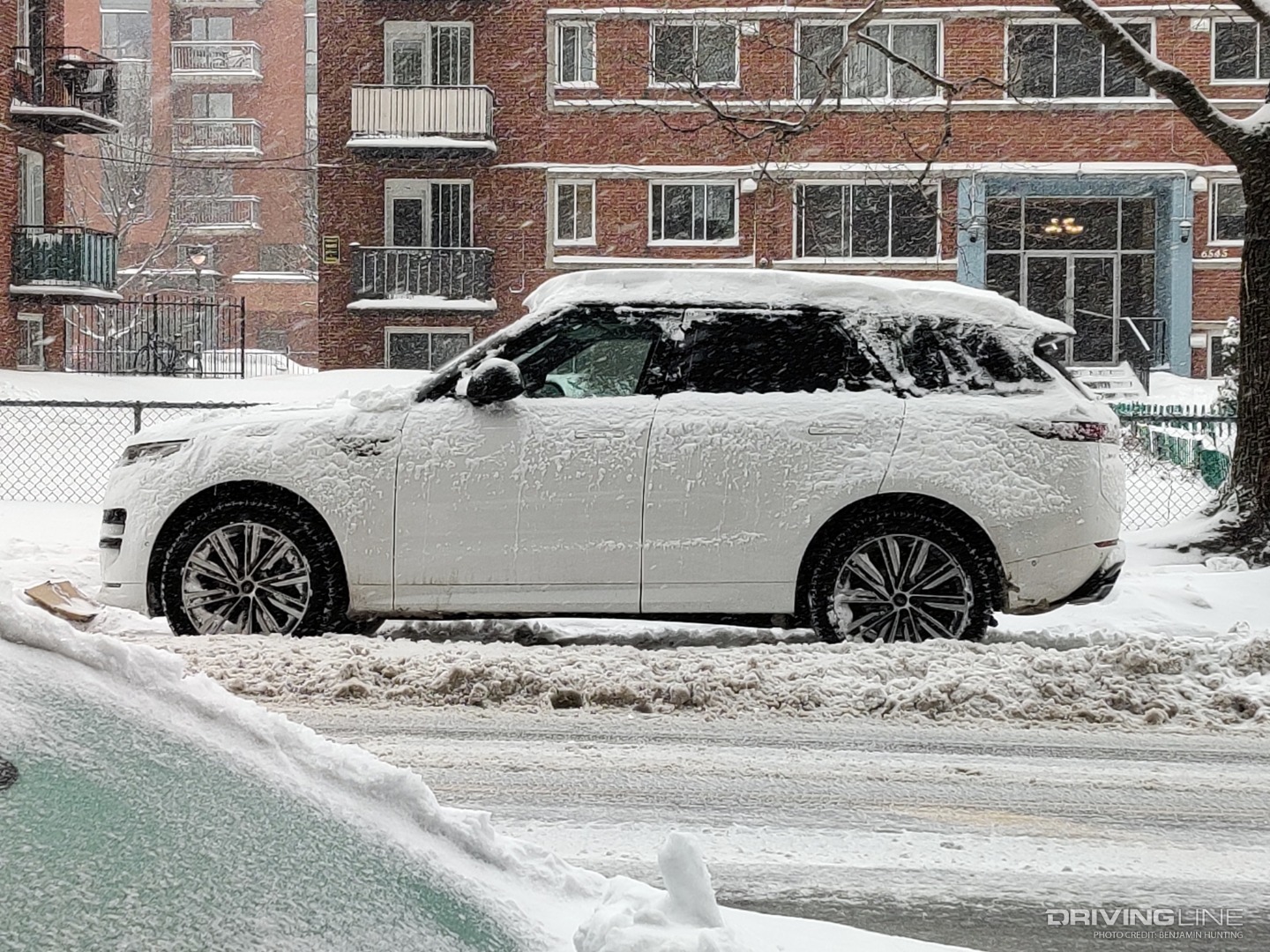 2023 Land Rover Range Rover Sport side profile covered in snow