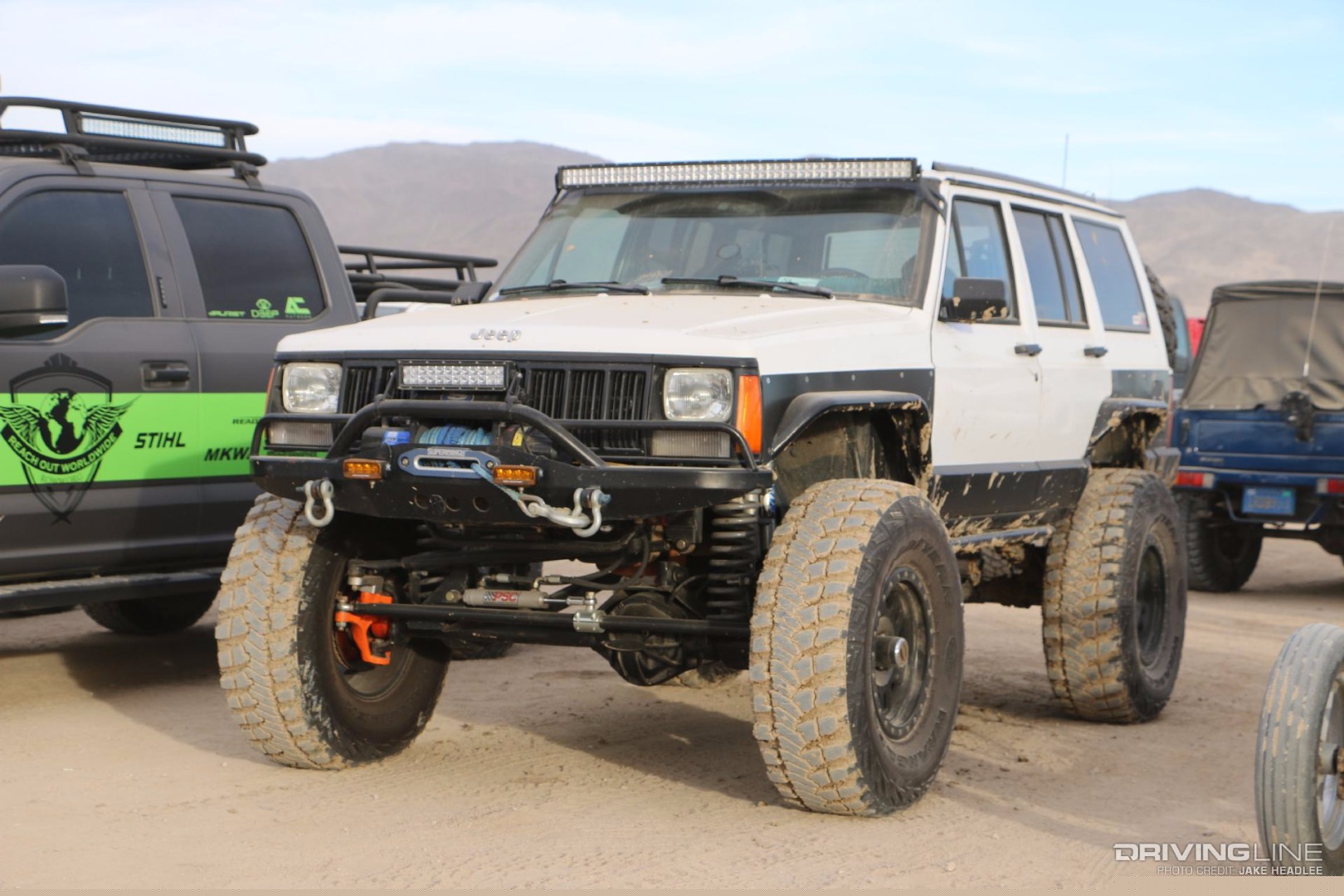 Jeep Cherokee with large tires and a light bar