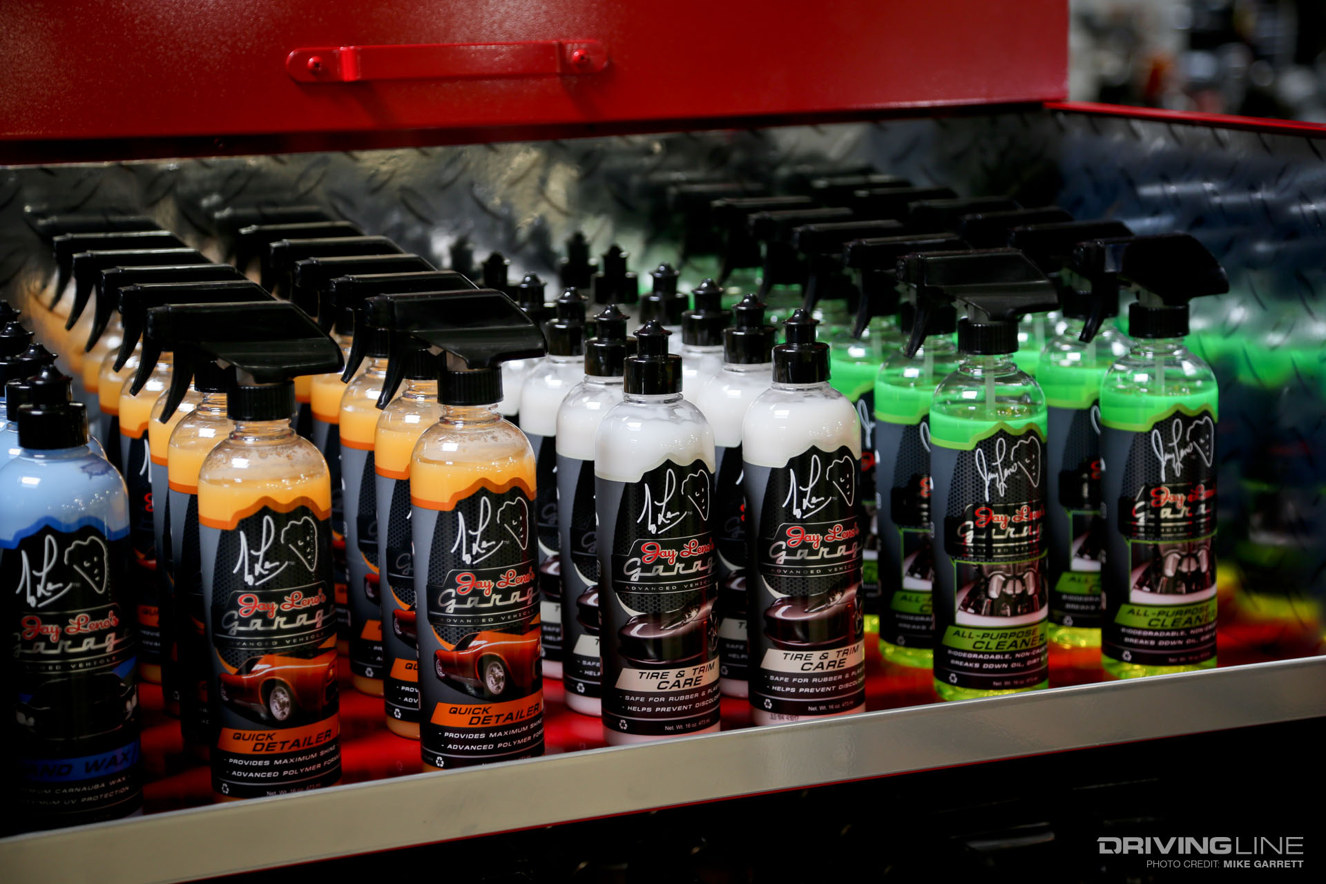 Bottles of blue, yellow, white and green car cleaning spray