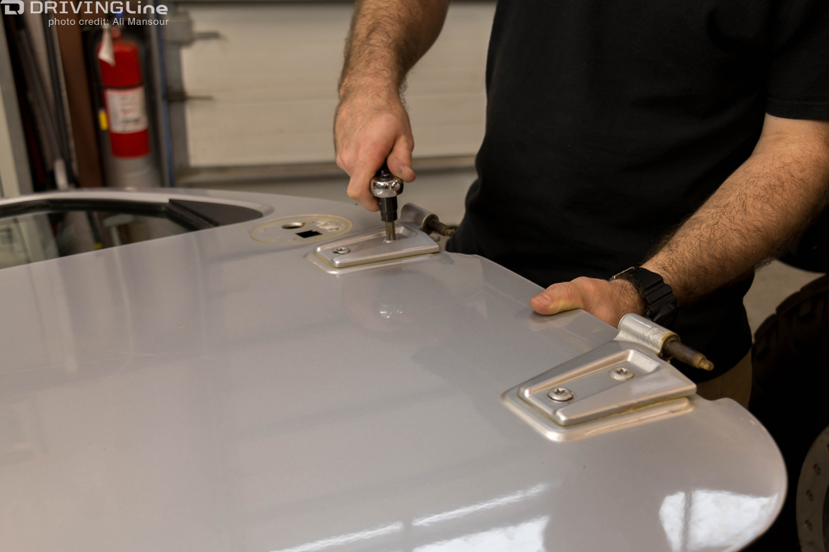 Man removing screws from a Jeep Wrangler door