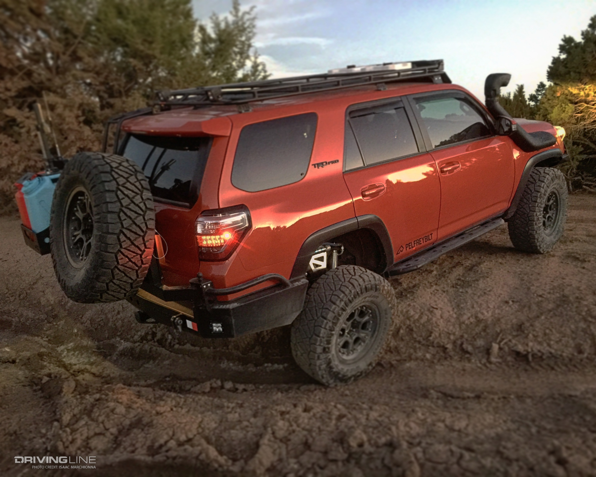 Toyota 4Runner on Nitto tires in red, climbing berm