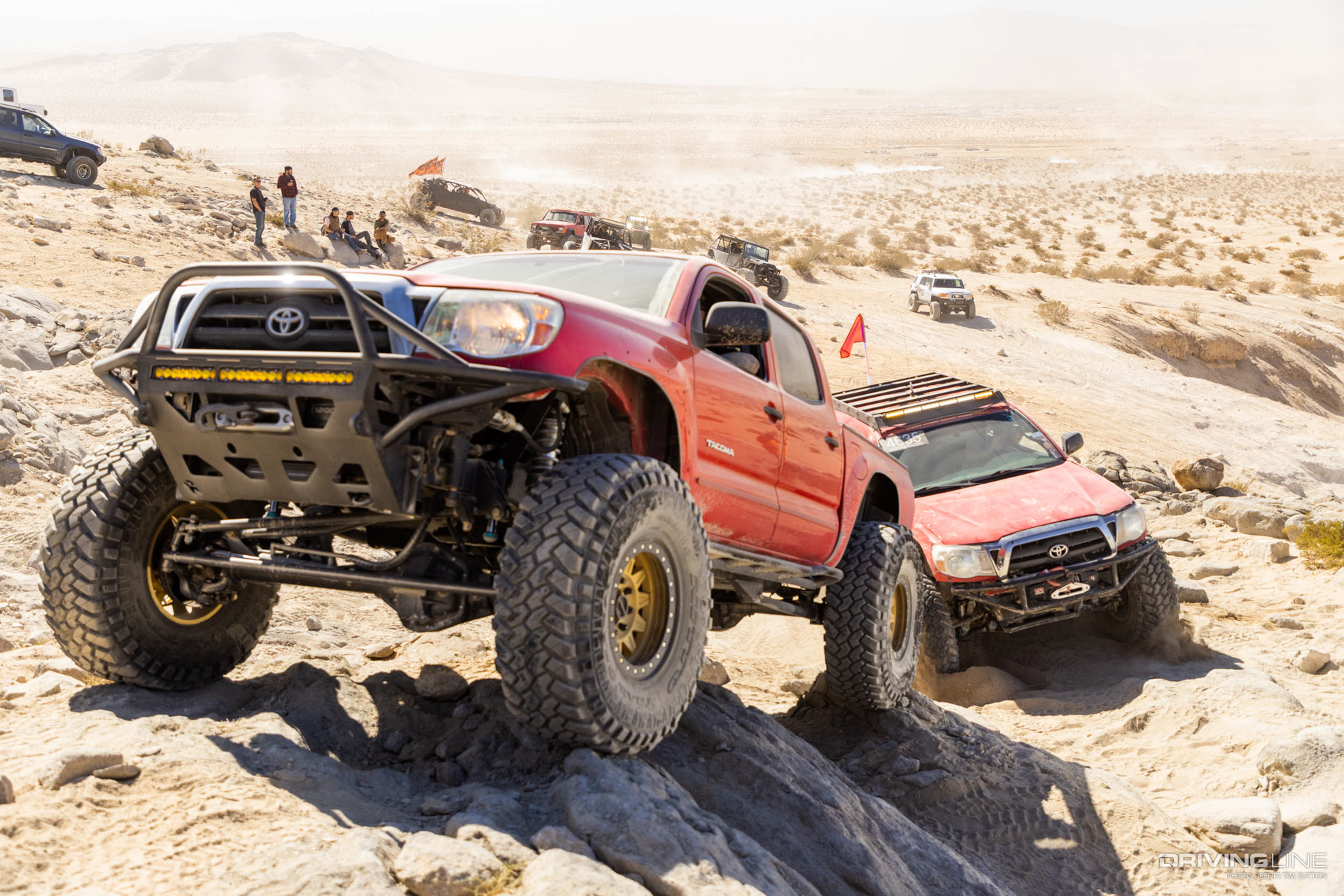 Red Toyota Tacoma on 40-inch Nitto trail Grappler tires