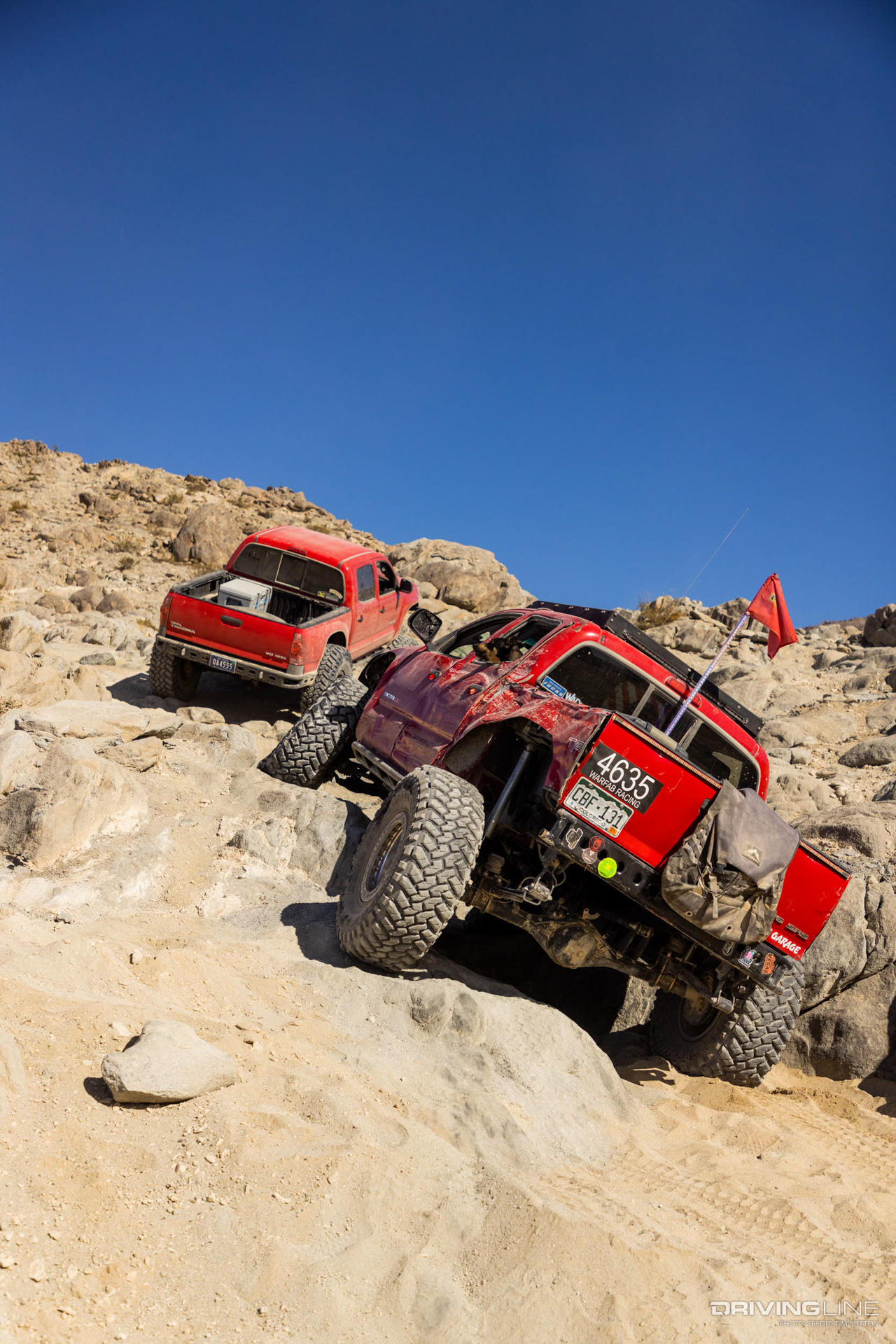Battered off-road Toyota tacoma wheeling up rocks in Johnson Valley
